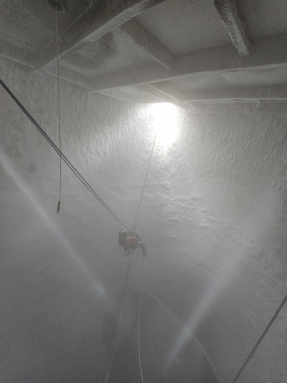 Rope access descending inside the silo