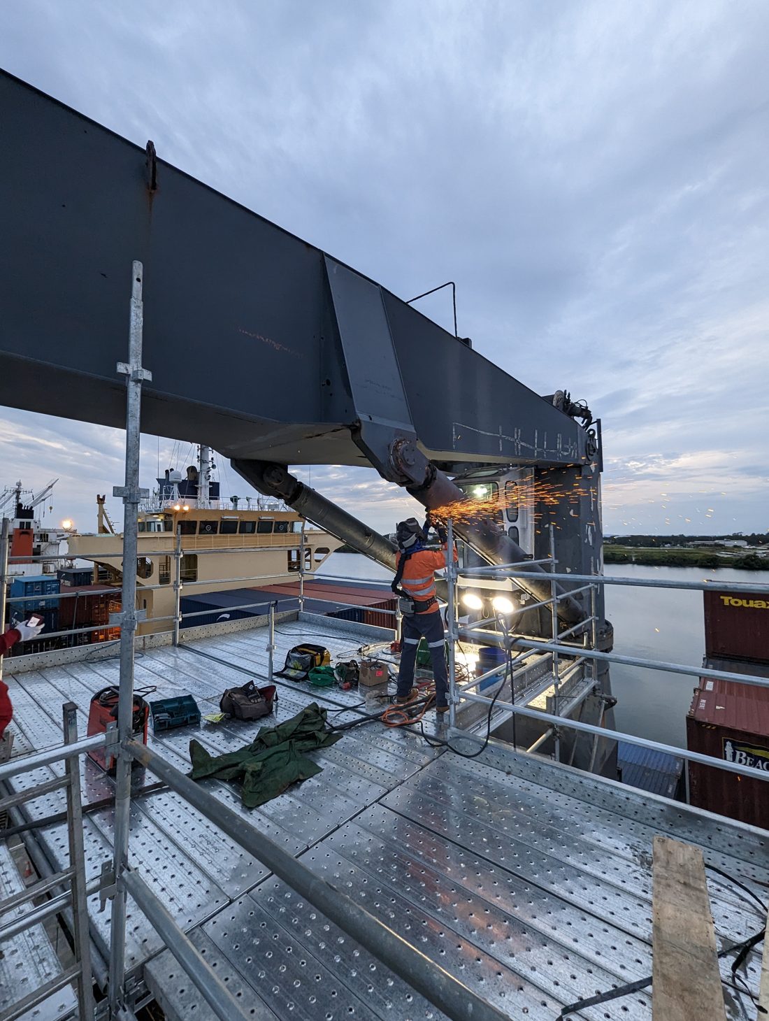 FosRich technician cutting a ship's deck crane during a wharfside repair